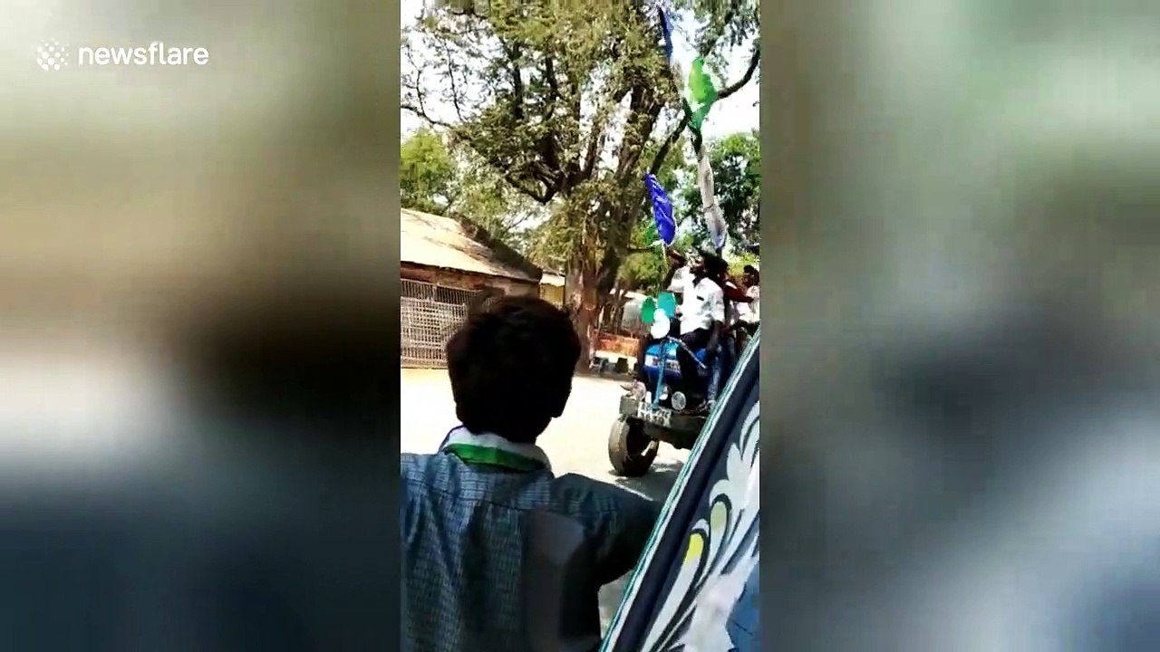 Men drink beer on tractor while canvasing for prohibition candidate in India