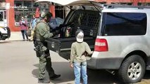 Young boy in awe as heavily armed police officer prepares for 'possible standoff' in Denver