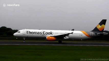 Condensation clouds engulf plane's wings as it takes off from Manchester Airport