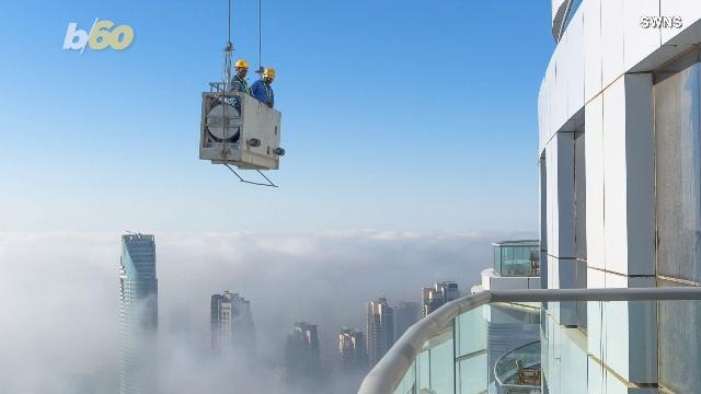 Don't Look Down! Vertigo-Inducing Photos Show Window Washers Working On One of the World's Tallest Skyscrapers
