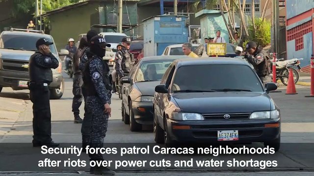 Police patrols after riots erupt in Caracas amid power rationing