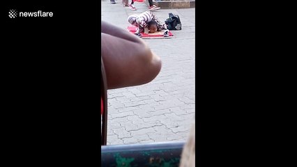 Young girl on street in Kenya shows off mind-bending contortion skills