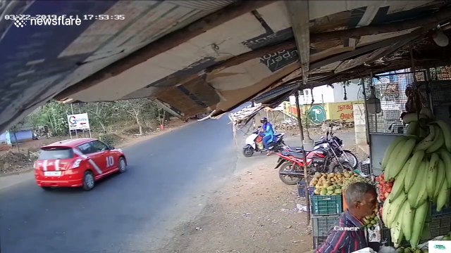 Horrific moment two mopeds smash together in the middle of a busy road