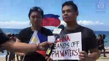 Otso Diretso supporters raise PH flags to oppose Chinese vessel in Batangas