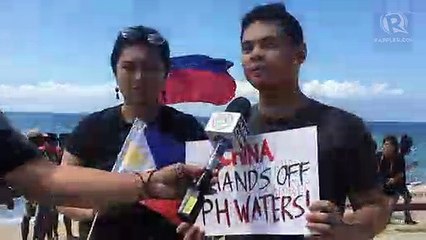 Otso Diretso supporters raise PH flags to oppose Chinese vessel in Batangas
