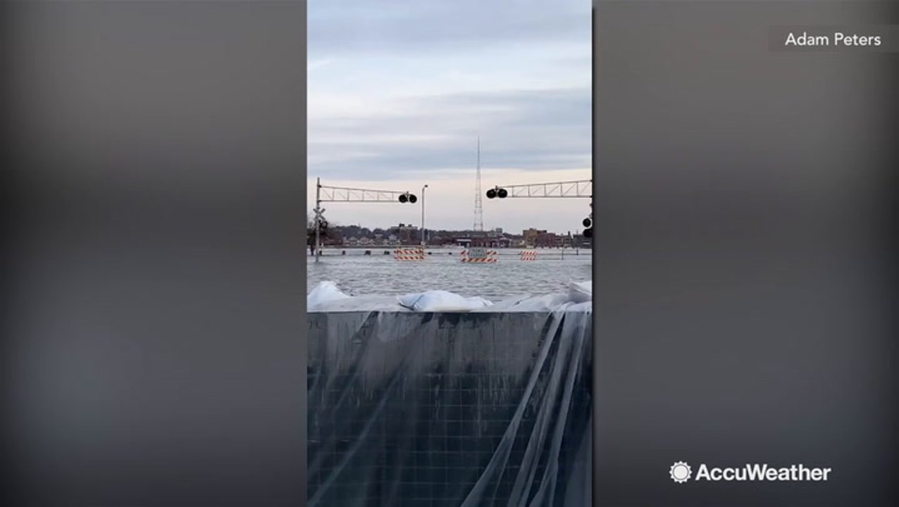 Barrier keeps river floodwaters from spilling into town