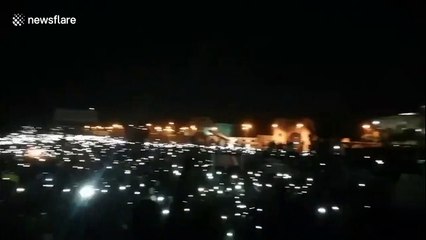 Thousands protest outside Sudan army HQ with phones in the air