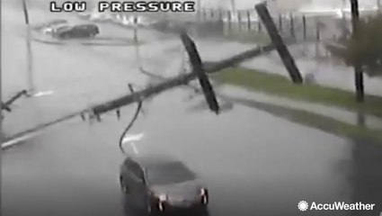 Dramatic video shows car hit by a pole as power lines fall