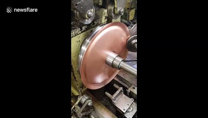 Hypnotic 'metal spinning' machine perfectly shapes copper disc into dome
