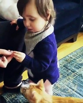 Cette fillette mange la croquette du chat au lieu de la donne !