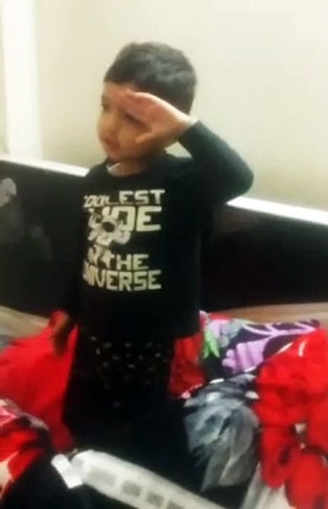 Cute boy standing on National Anthem