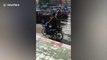 Policeman makes motor scooter rider do push-ups as punishment