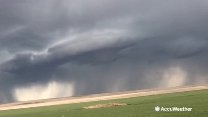Storm clouds loom over flatland