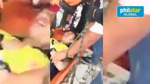 Firemen are jubilant following the rescue of another survivor earlier trapped inside the collapsed Chuzon supermarket in Porac, Pampanga