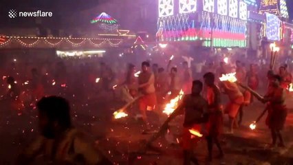 Indian devotees engage in fire-throwing fight to appease Hindu goddess