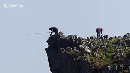 Spanish fishermen risk their lives catching sea bream from top of steep cliff