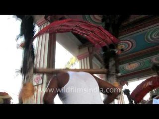 Men dancing with large palanquins on their shoulders!