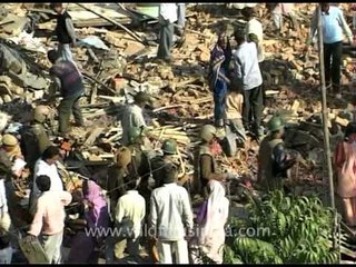 Gathering what the wreckers left behind after slum demolition in New Delhi