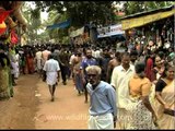 Lord Ayappans' devotees pass through a market place