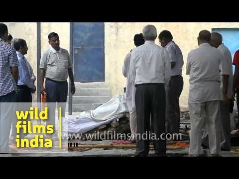 Family placing dead body on pyre for cremation