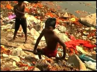 Polio afflicted rag picker near the filth of Yamuna river