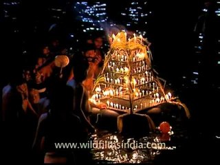Devotees releasing lighted lamps to river pampa