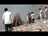 Hindus cremating dead bodies on the banks of the Ganges river in India