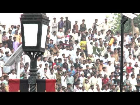 Jinnah's portrait with Pakistani crowd cheering for Flag down ceremony, Wagah border