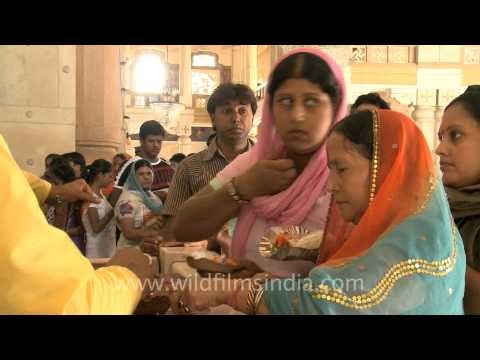 Devotees offering prayer to Lord Krishna on the occasion of Janmashtami
