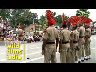 Indian soldier walks while kicking his feet up to his forehead, Wagah Border