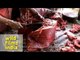 Indian butcher chopping pork ribs