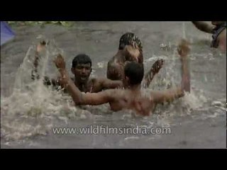 Grown men play like children in a Kerala lake after a monsoon shower!