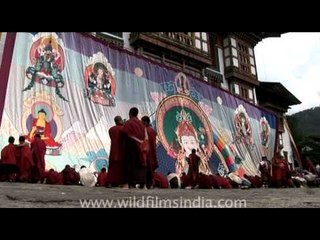 Colourful old thangka or thongdrel being unfurled on Guru Rimpoche's birthday!