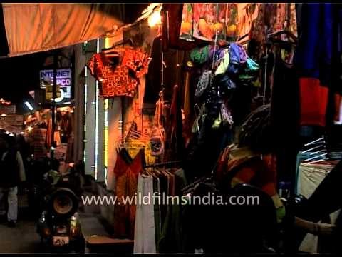 Foreigner waves at the camera while shopping at Pushkar fair, Rajasthan