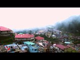 Landour bazaar in monsoon, with mist pouring over the ridge