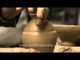 Spinning the wheel to mould clay into diyas for Diwali, Delhi
