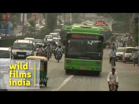 Chaotic traffic moves along a busy road in New Delhi