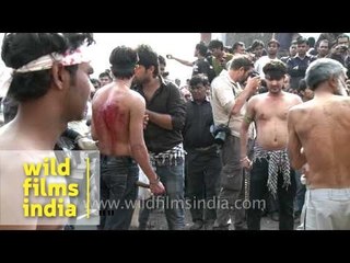 Old man flogging himself with sharp metal blades on Muharram