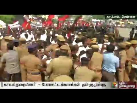 Tussle between the police and DMK cadres, who get past the barricade at Tambaram to stage rail roko