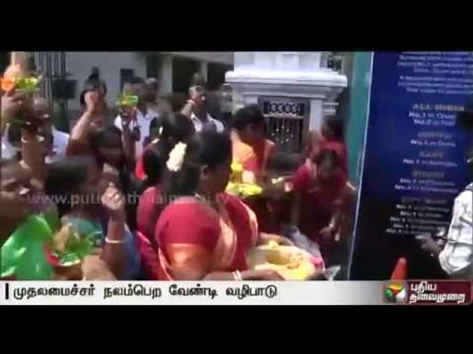 ADMK cadres offer prayers and charity  in front of the hospital for CM's complete recovery