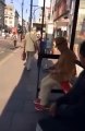 Shahbaz Sharif sitting in a bus stop in central London using his mobile phone