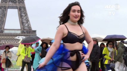 Modelos de talla grande desfilan delante de torre Eiffel contra la dictadura de modistas
