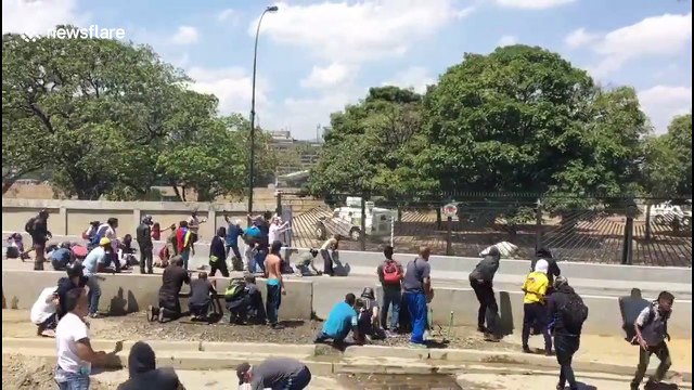 Venezuelan riot police deploy water cannon against rock-throwing protesters in Caracas