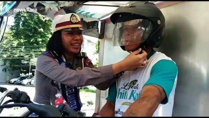 Indonesian police remind road users to take care by handing out flowers