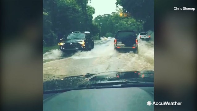 Cars battle flooded roads after heavy rain