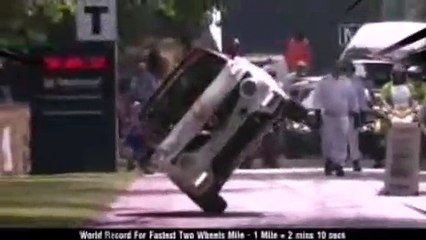 Man is driving car on two wheels