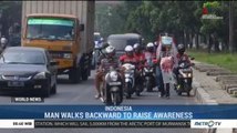 Man Walks Backward to Raise Awareness