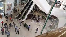Debris plunges from fifth floor escalator as heavy rain batters Philippines shopping mall