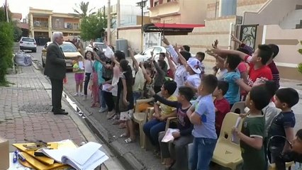 Watch: Retired teacher keeps kids off video games with Iraq street school