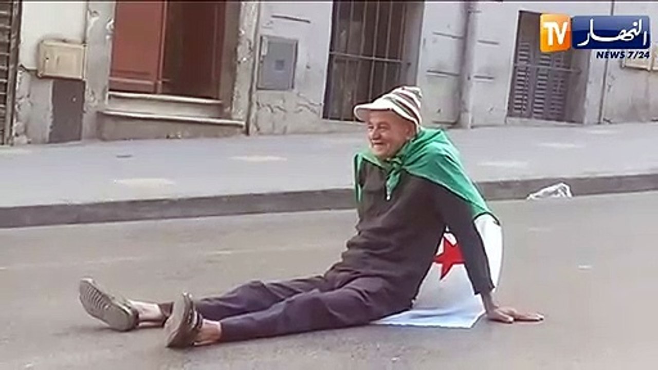 شاهد.. عجوز يجلس أرضا بعد أن أنهكه الصيام والتعب في مسيرة الجمعة الـ 12